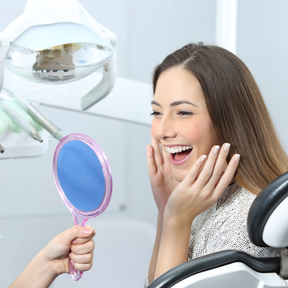 The image shows a modern office space with a sleek desk, chair, and computer setup, featuring wood paneling, a white countertop, and a contemporary design.